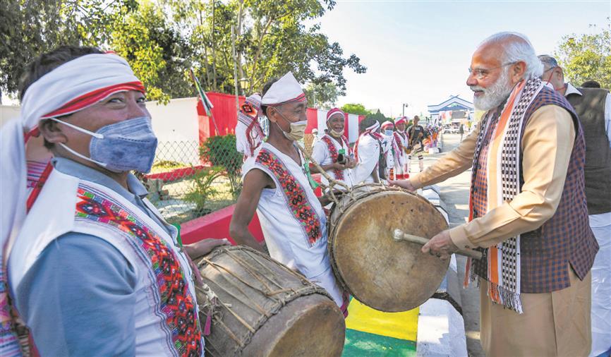 Prime Minister Narendra Modi plays a drum during his visit to Manipur on Tuesday. PTI